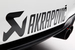 BMW 1er M Coupe als SafetyCar bei der MotoGP. Schriftzug des Sponsors Akrapovic.