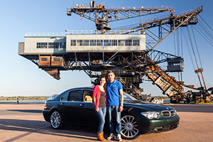 Chris ('750li') mit Freundin Natalie und seinem BMW 750Li (E66) vor dem Mad Max Eimerkettenbagger